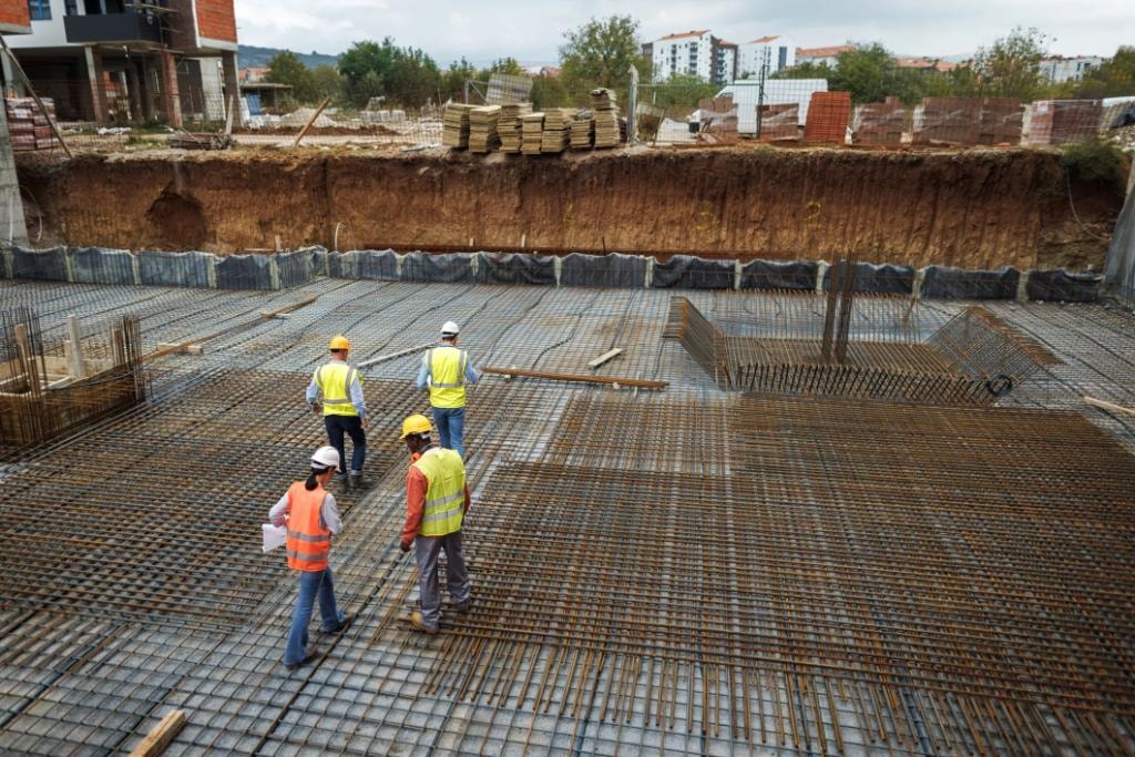 Construction workers on rebar foundation site