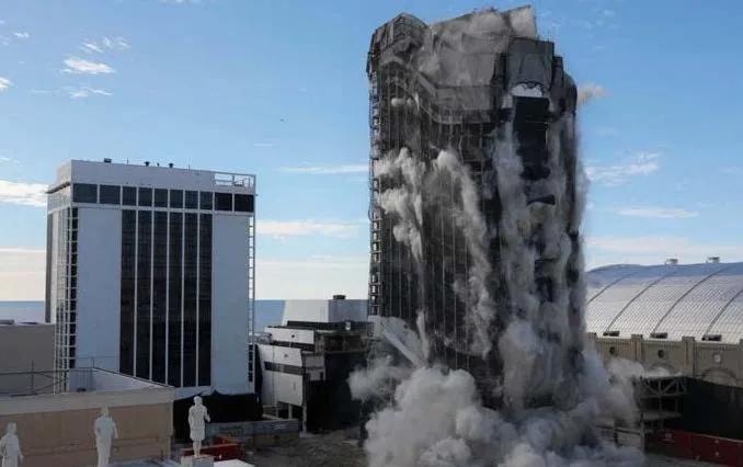 Building implosion demolition with dust clouds