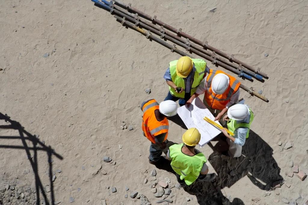 Engineers reviewing blueprints at construction site